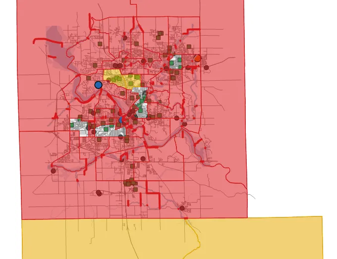 A map of Cedar Rapids census tracts mostly shaded red, with translucent blue water along the rivers and creeks, red road segments, one yellow tract northwest of the center, a few pale tracts, two blue circle markers and one orange circle marker.